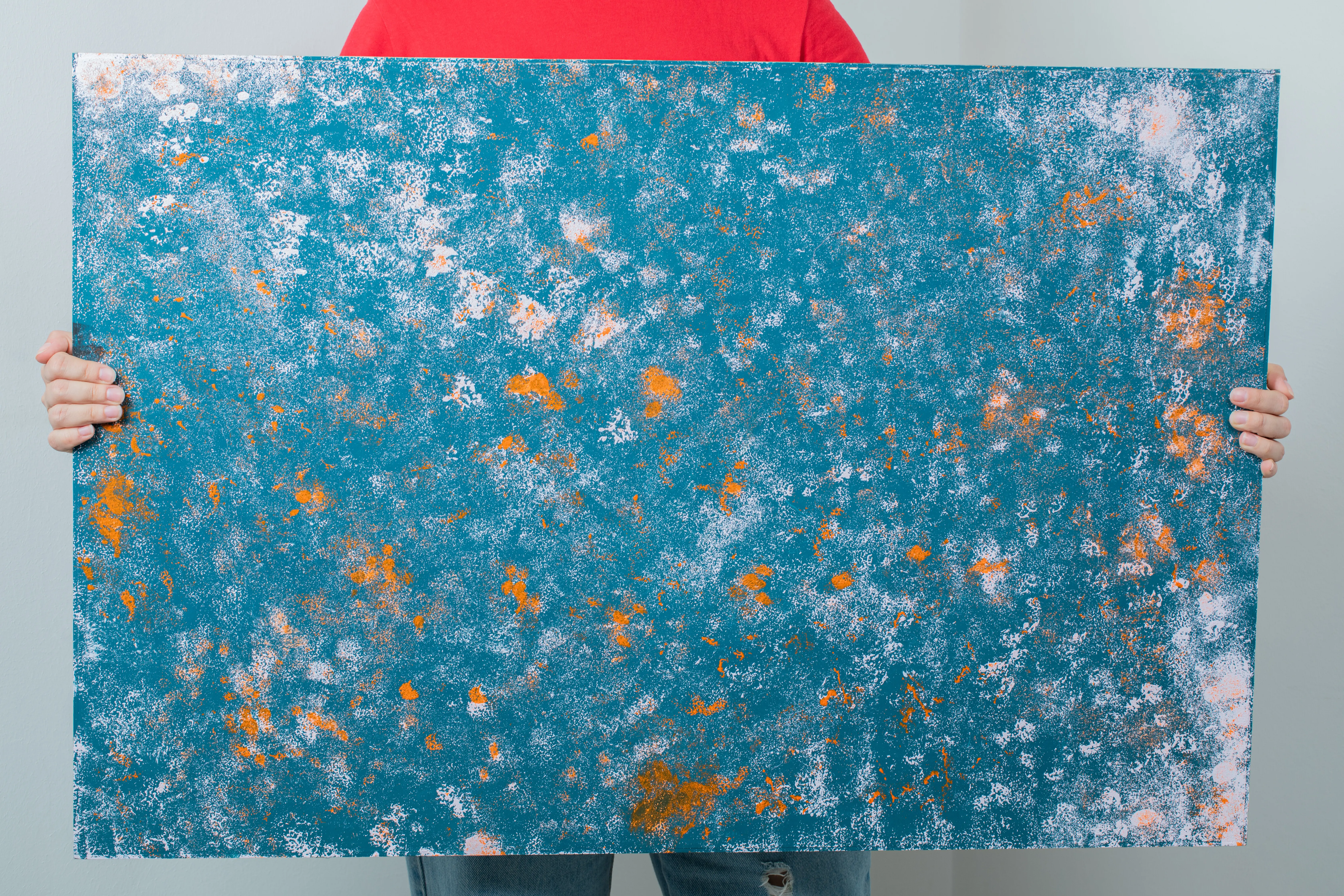 Ein Mann hält eine blaue Fotofläche.